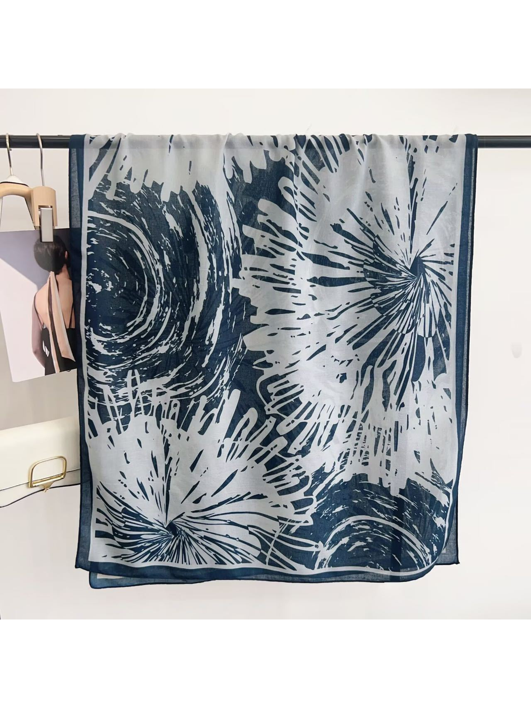 Blue abstract-pattern scarf displayed open with contrasting border