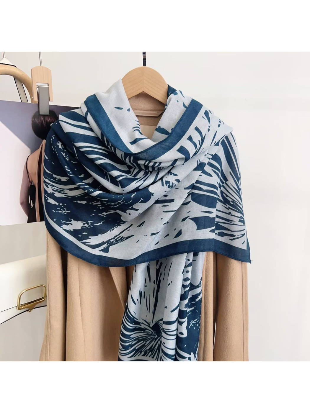 Blue abstract-pattern scarf draped over a coat