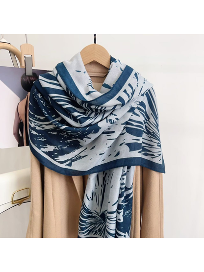 Blue abstract-pattern scarf draped over a coat