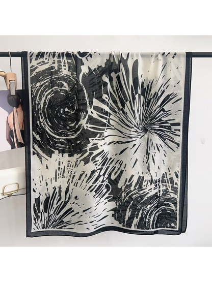 Black abstract-pattern scarf displayed open with contrasting border
