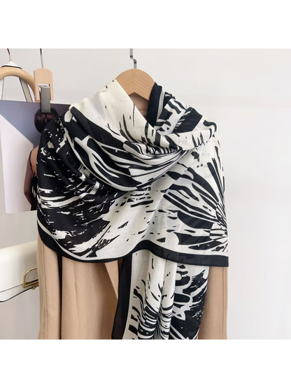 Black abstract-pattern scarf draped over a coat