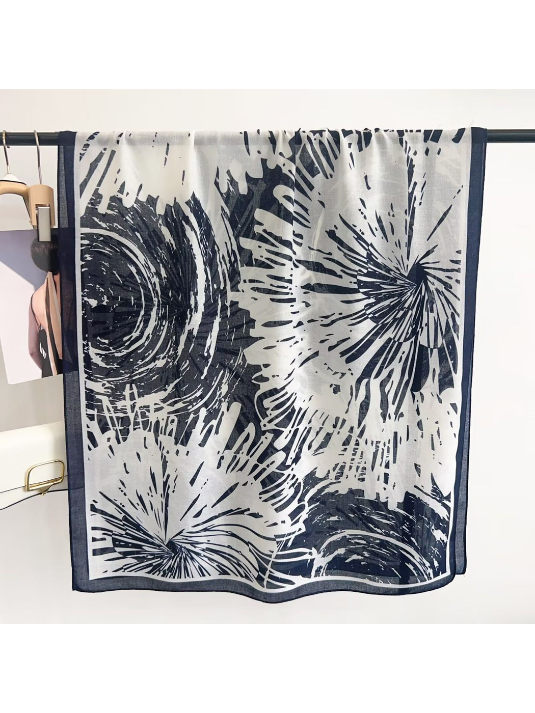 Navy abstract-pattern scarf displayed open with contrasting border