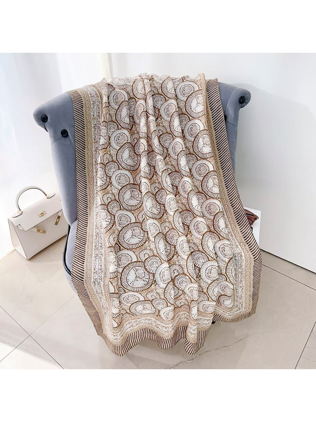 Brown ornamental scarf draped across an armchair