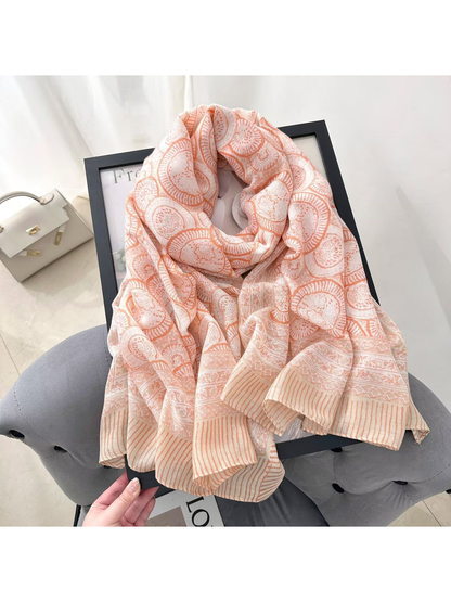 Orange ornamental scarf arranged on an armchair