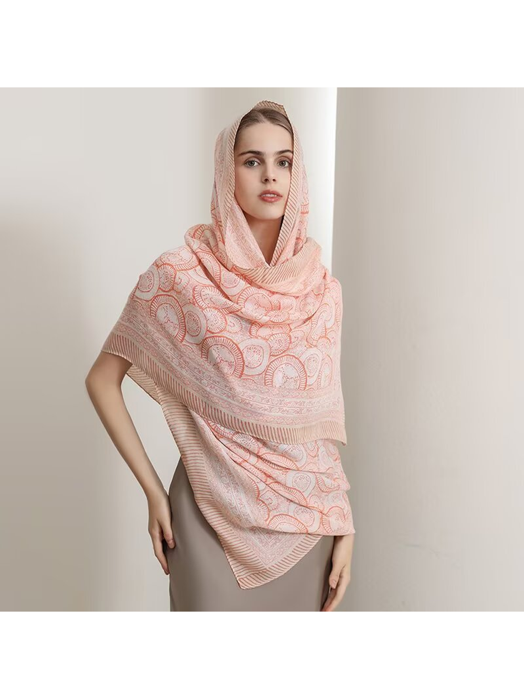 Orange ornamental scarf styled over the head and shoulders