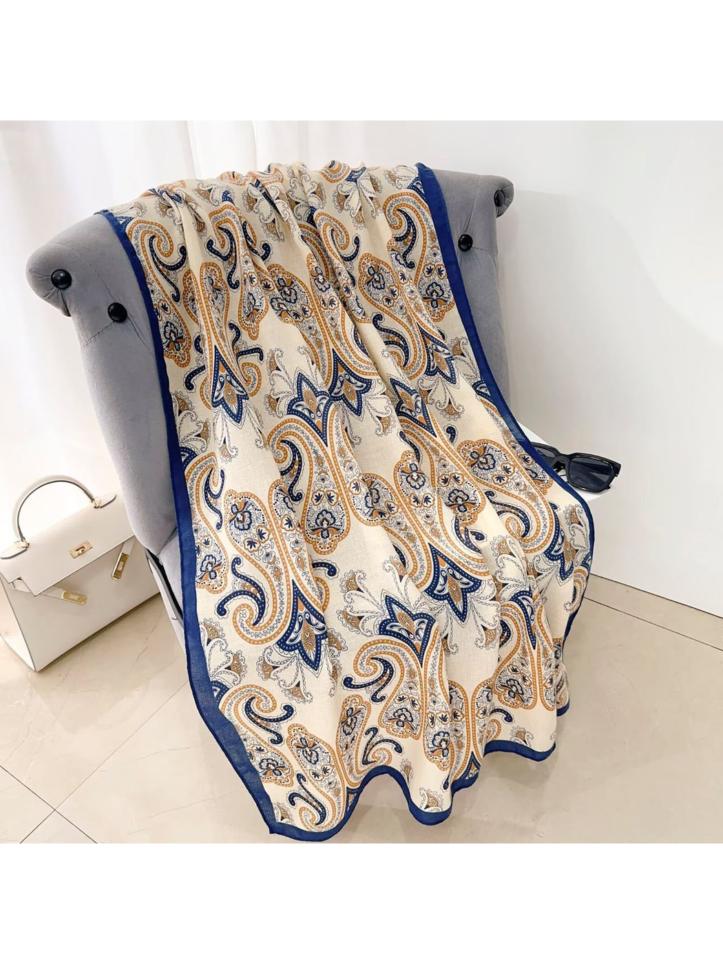 Navy Orange paisley scarf draped over a chair