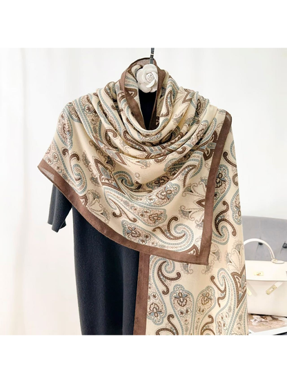 Brown paisley scarf styled around a dress form