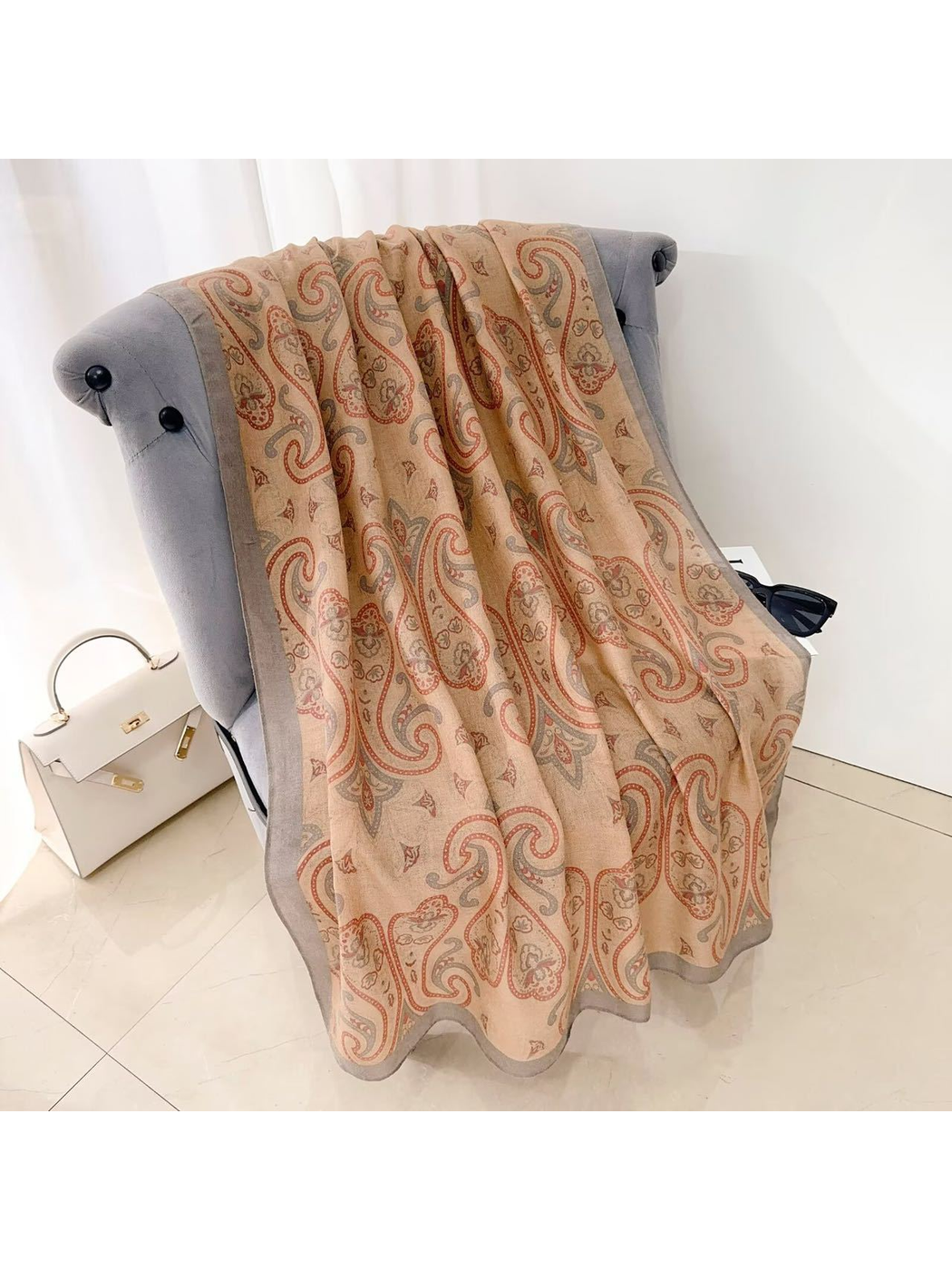 Camel paisley scarf with a gray border, draped view