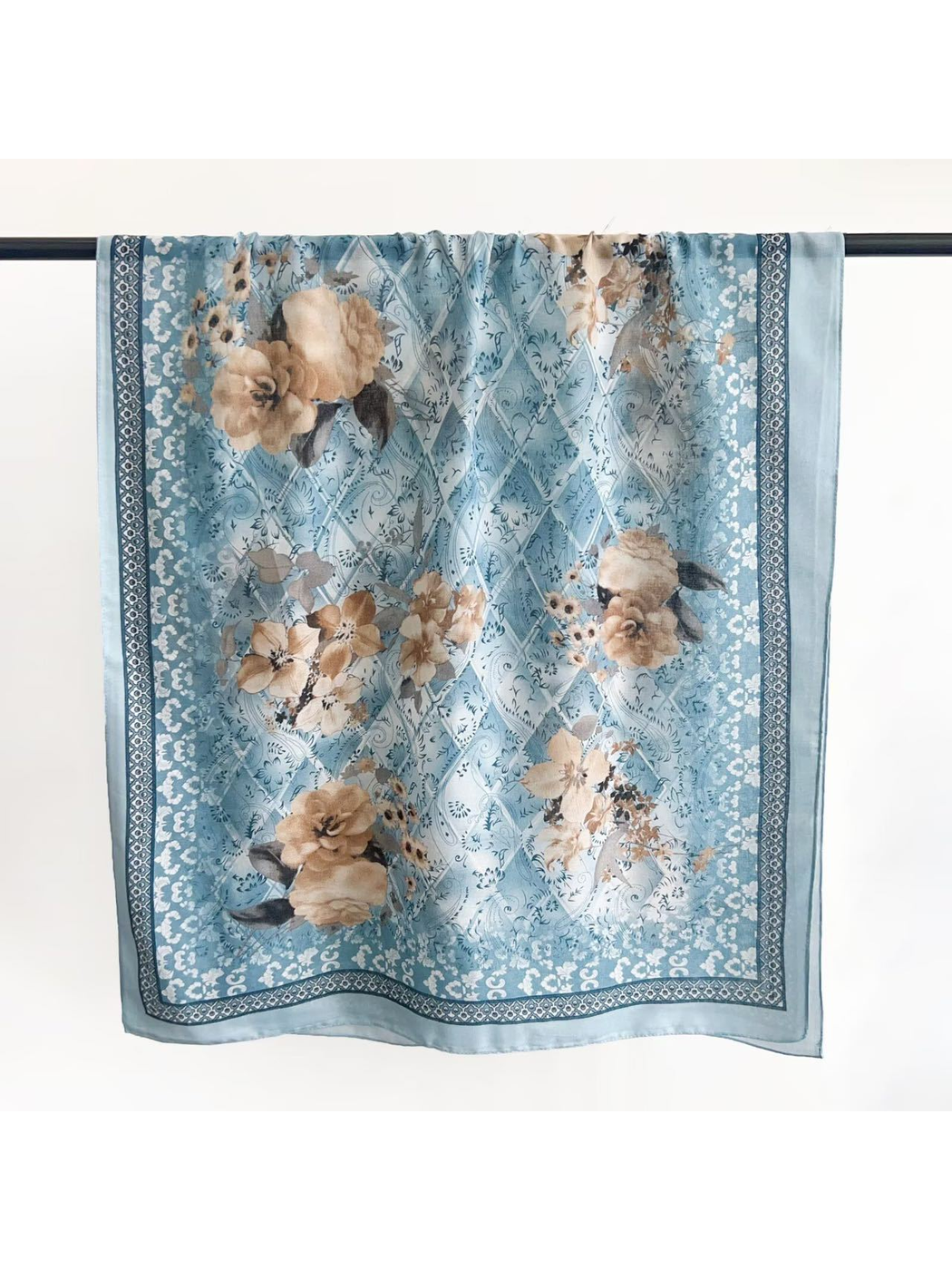 Light blue floral scarf with ornamental linework and geometric border