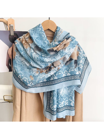 Light blue floral scarf draped around a coat hanger