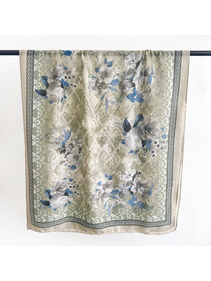 Green floral scarf with blue accents and geometric border