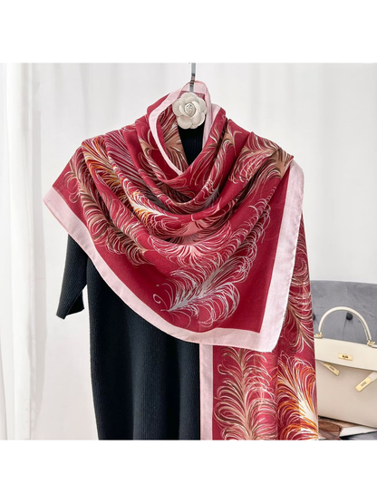 Burgundy feather-pattern scarf draped over a black top