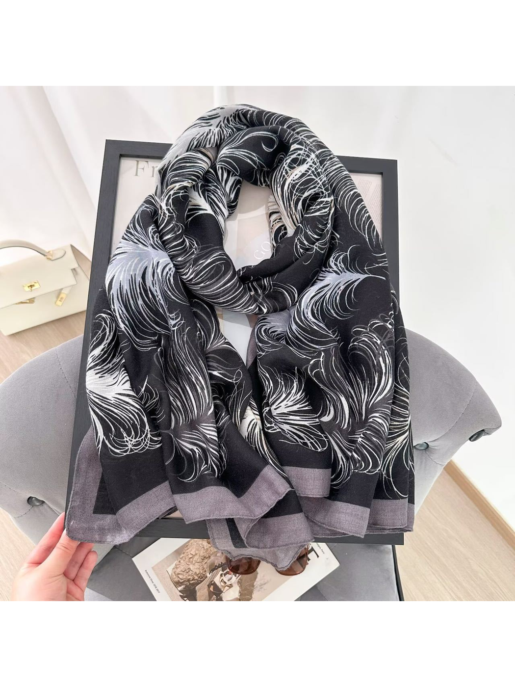Black Gray feather-pattern scarf arranged in a looped drape