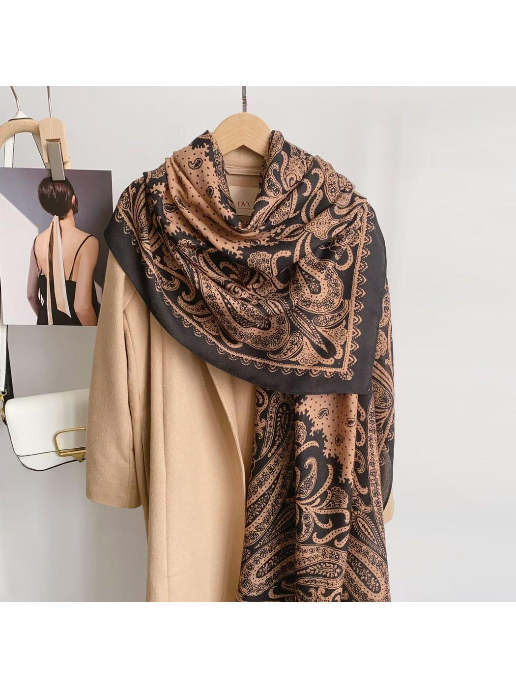 Black Camel paisley scarf draped over a camel coat