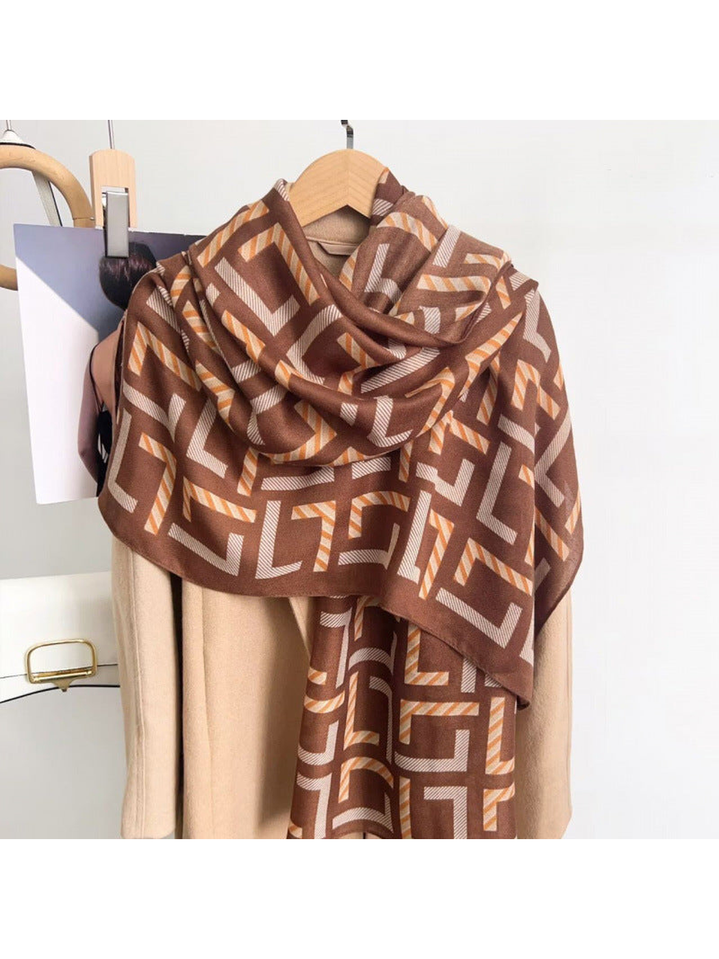 Brown geometric scarf draped over a coat