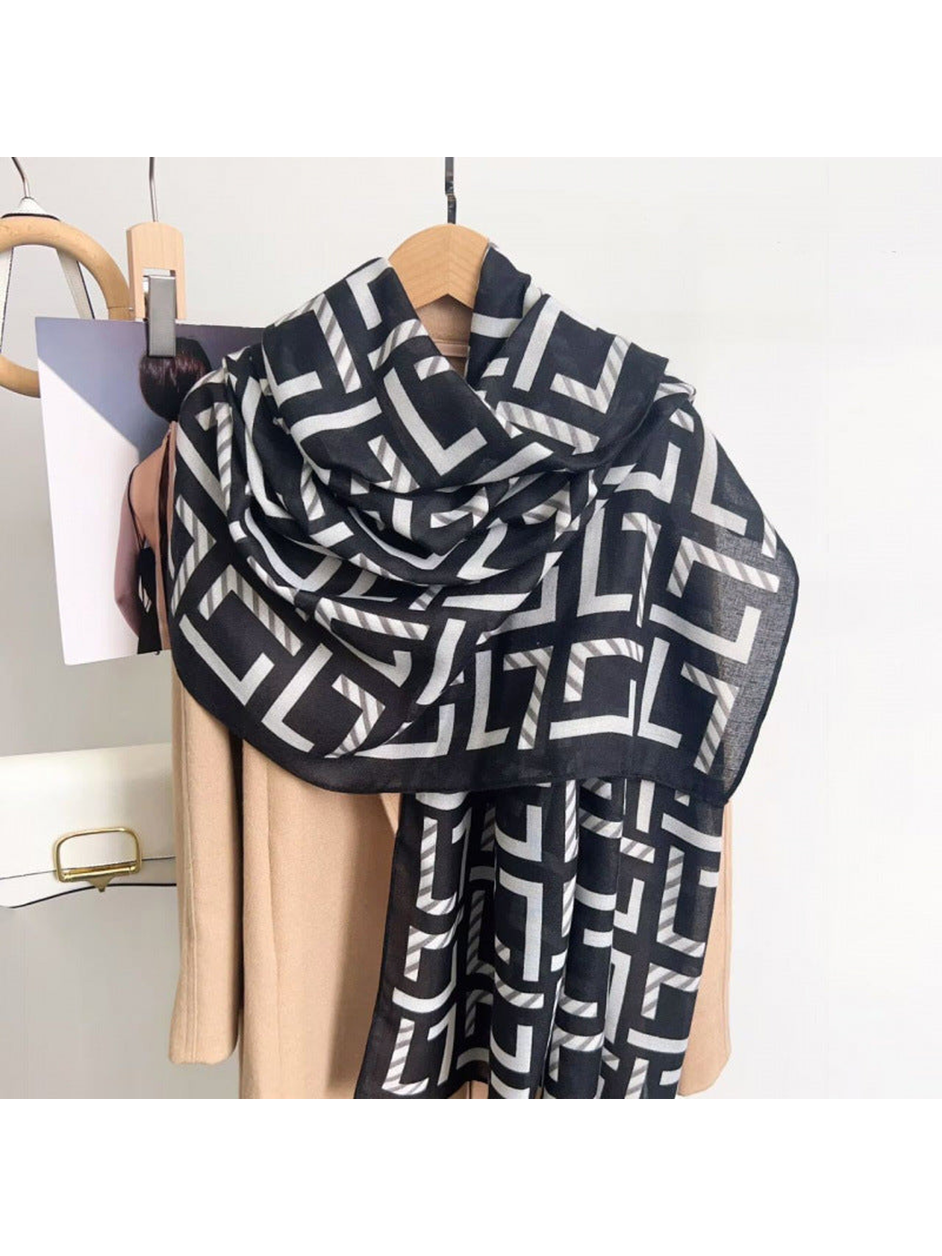 Black Gray geometric scarf draped over a coat