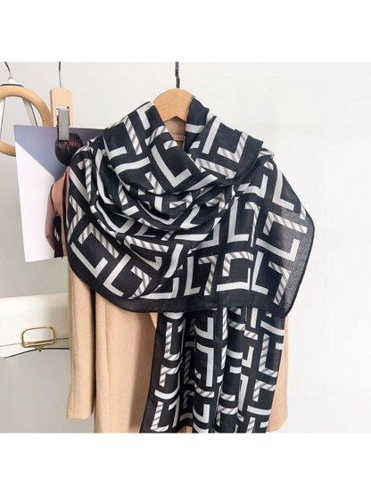 Black Gray geometric scarf draped over a coat