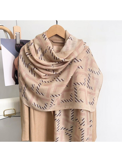 Beige geometric scarf draped over a coat