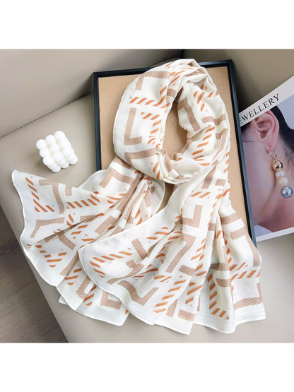 Ivory geometric scarf arranged in a looped flat lay
