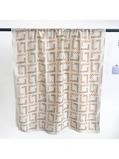 Ivory rectangular scarf displayed open to show the geometric pattern