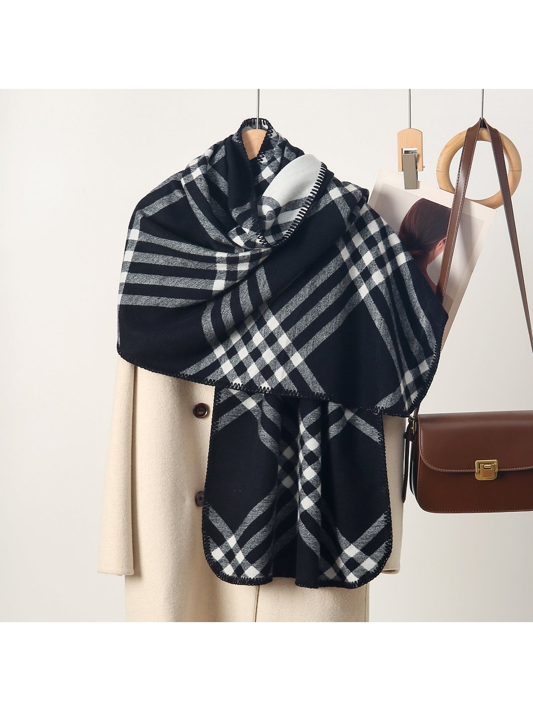 Black plaid rectangular scarf with rounded stitched edges, draped display