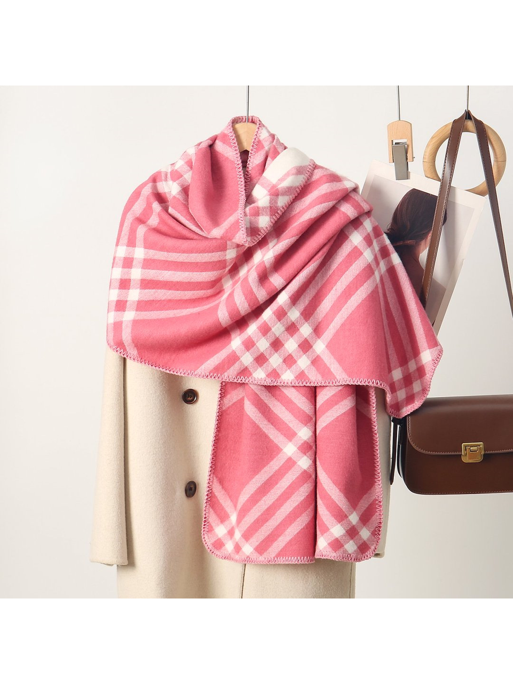 Pink plaid rectangular scarf with stitched edges, draped display