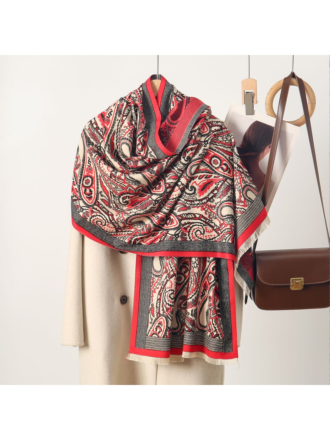 Red paisley scarf with contrasting striped border and short fringe, draped view