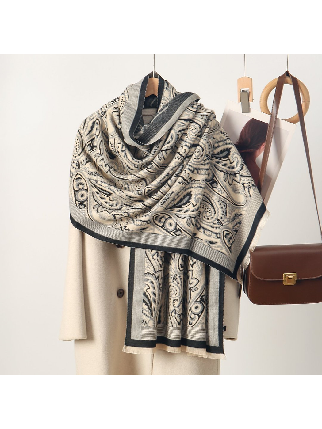 Gray paisley scarf with striped border and short fringe, draped view