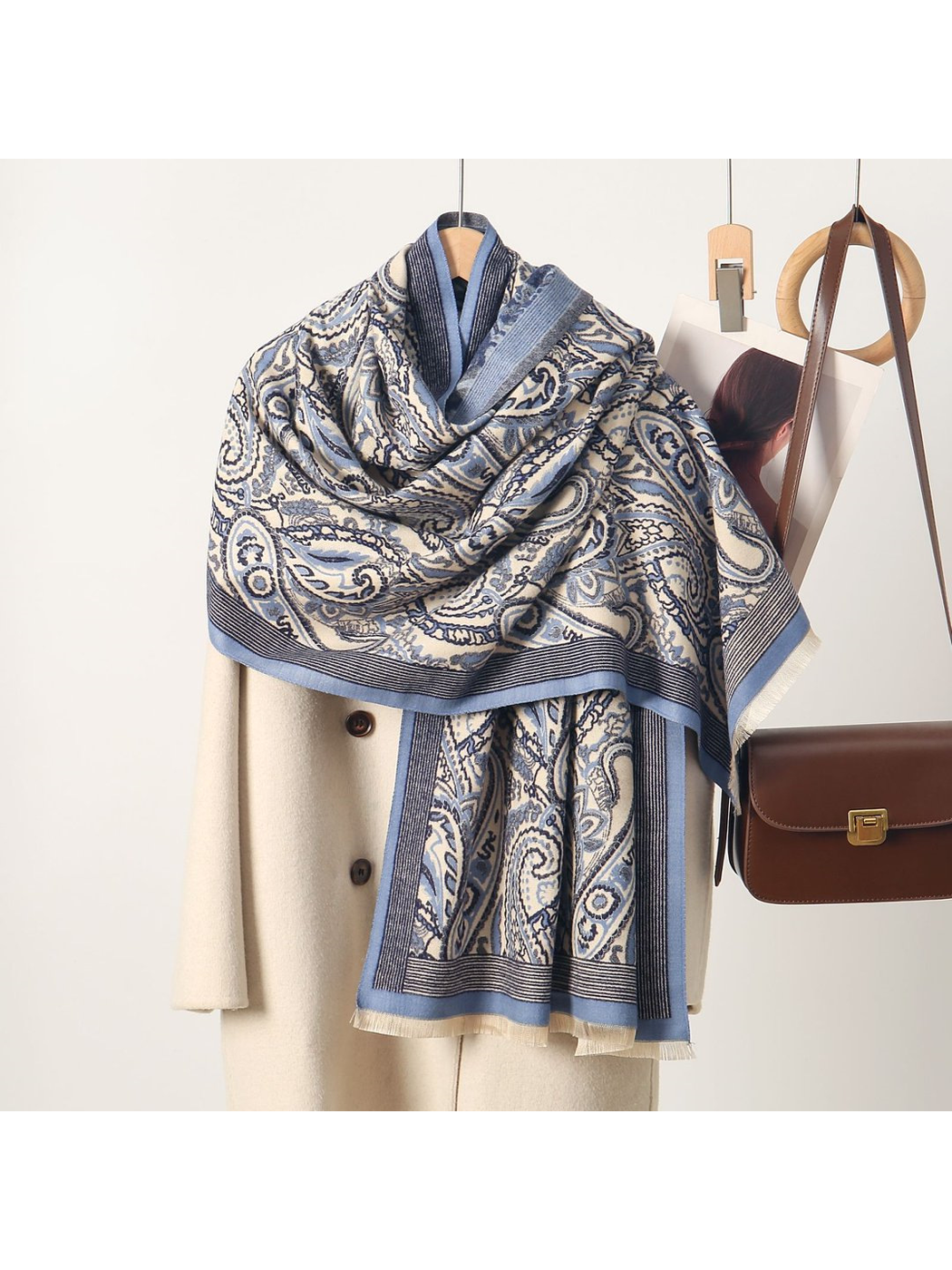Blue paisley scarf with striped border and short fringe, draped view