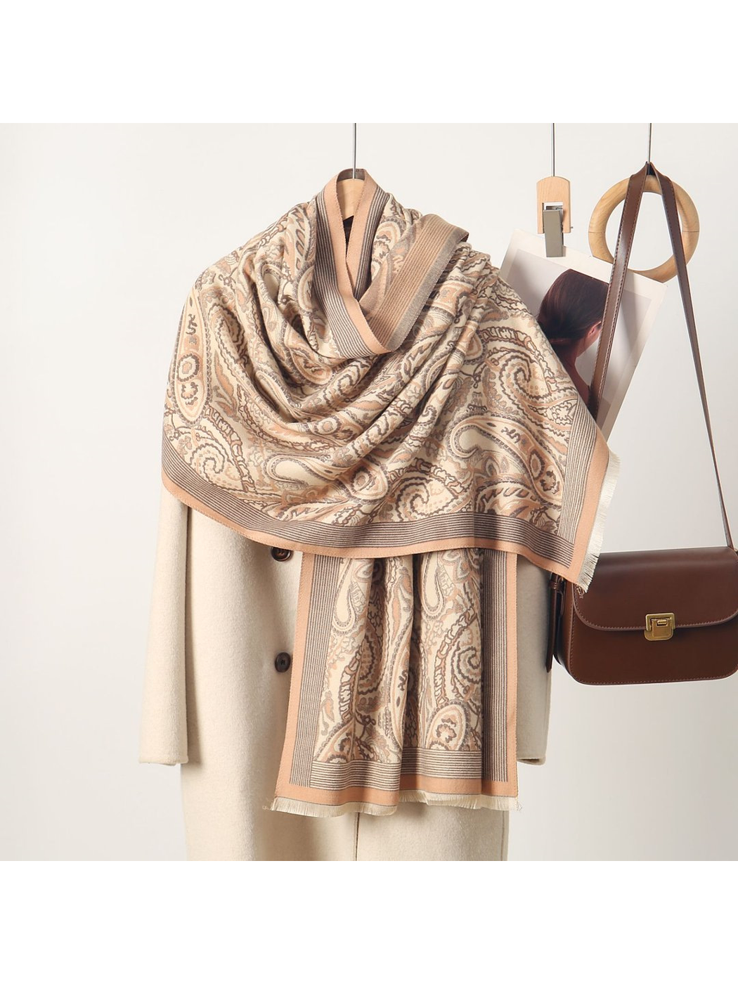 Beige paisley scarf with striped border and short fringe, draped view