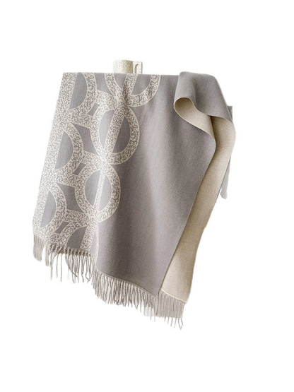 Gray geometric scarf draped to show the contrasting reverse and fringed ends