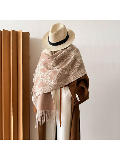 Greige geometric scarf styled as a wide shoulder wrap