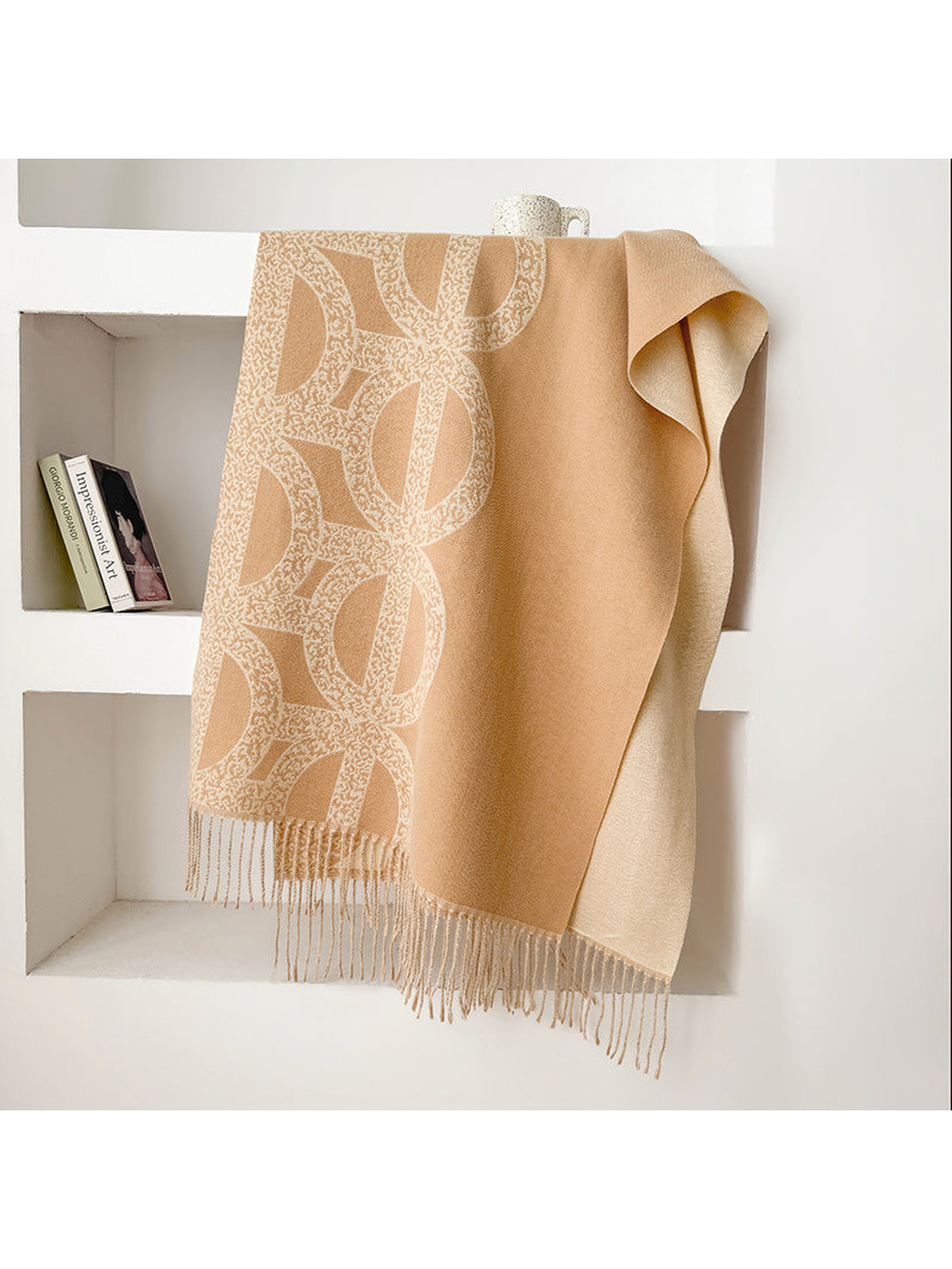 Khaki geometric scarf draped with a contrasting reverse and fringe
