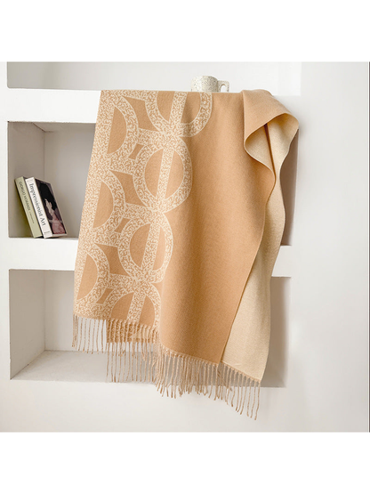 Khaki geometric scarf draped with a contrasting reverse and fringe