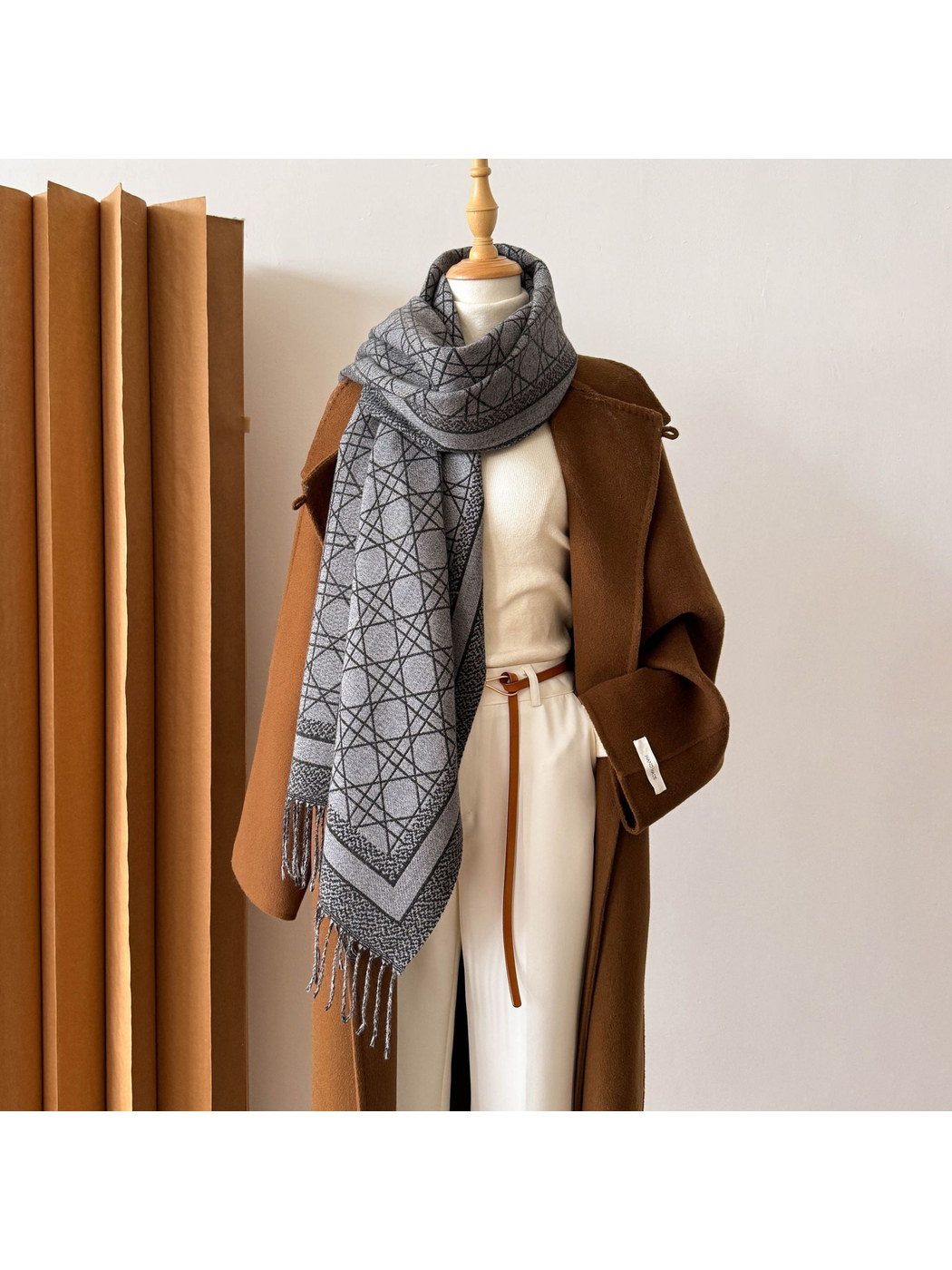 Black Gray abstract-line scarf looped at the neck with one fringed end draped forward