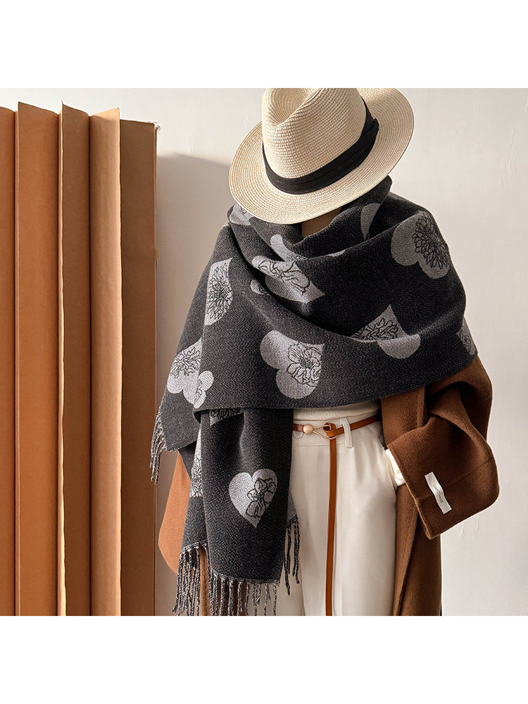 Black heart and floral scarf wrapped around a mannequin with a hat