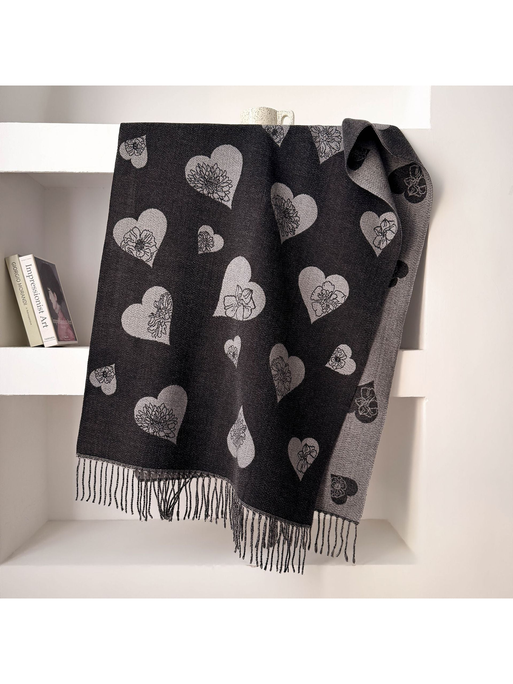 Black heart and floral scarf draped over white shelving