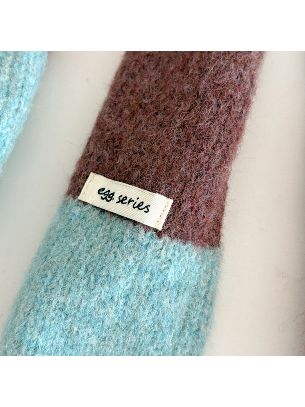 Close-up of the fuzzy striped surface and small fabric label