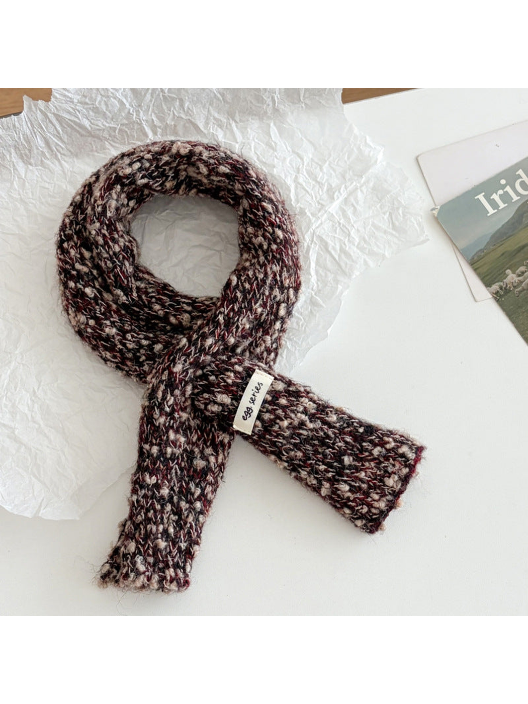 Burgundy narrow textured scarf arranged in a loop