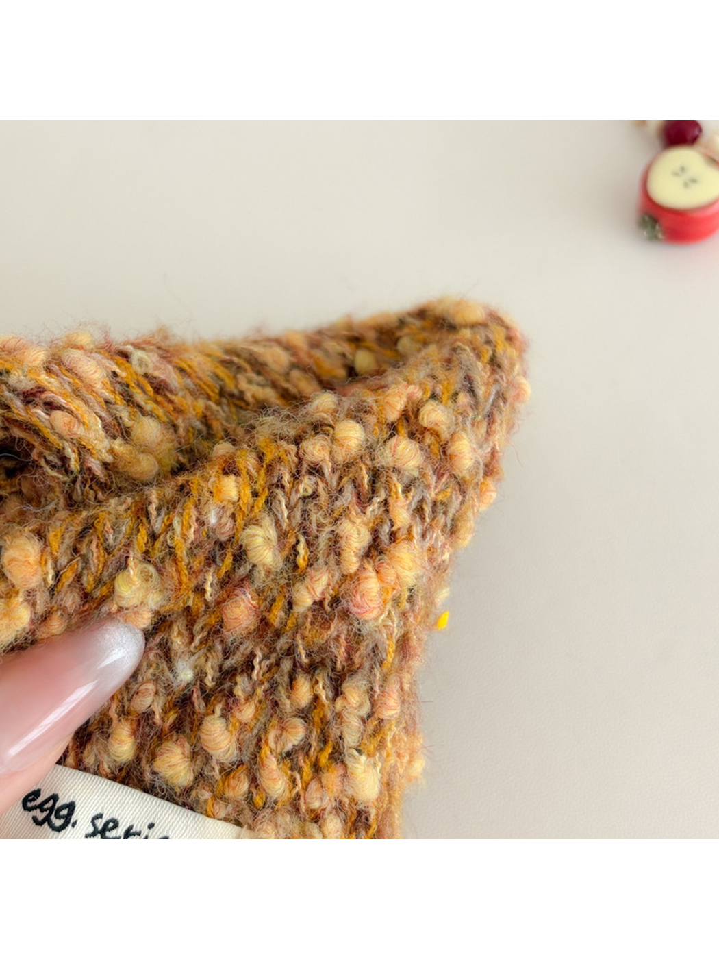 Close-up of the Orange Yellow scarf's raised looped texture and knit construction