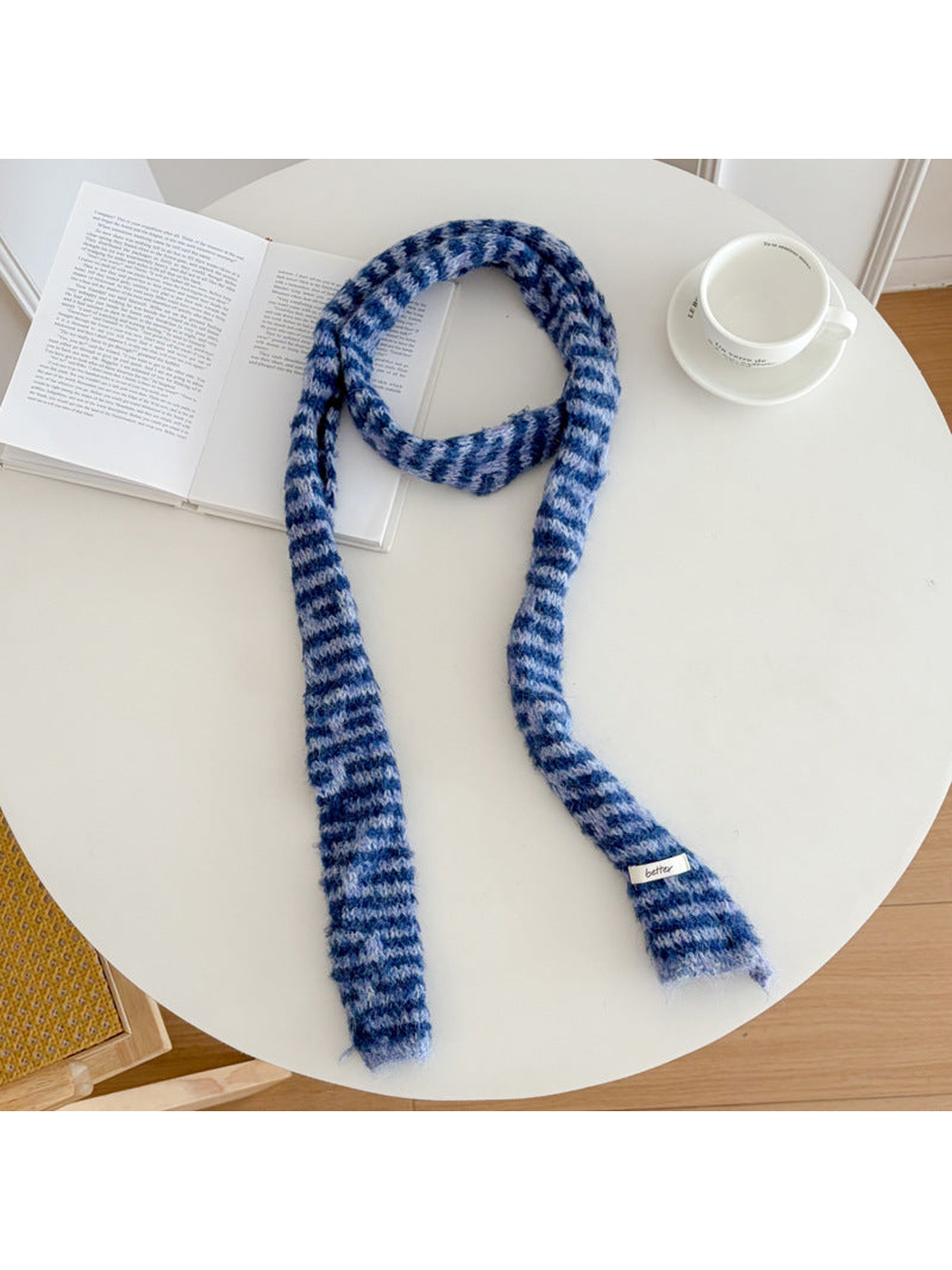 Blue fuzzy striped long narrow scarf laid flat