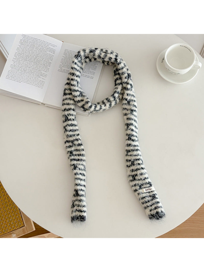 Black fuzzy striped long narrow scarf laid flat