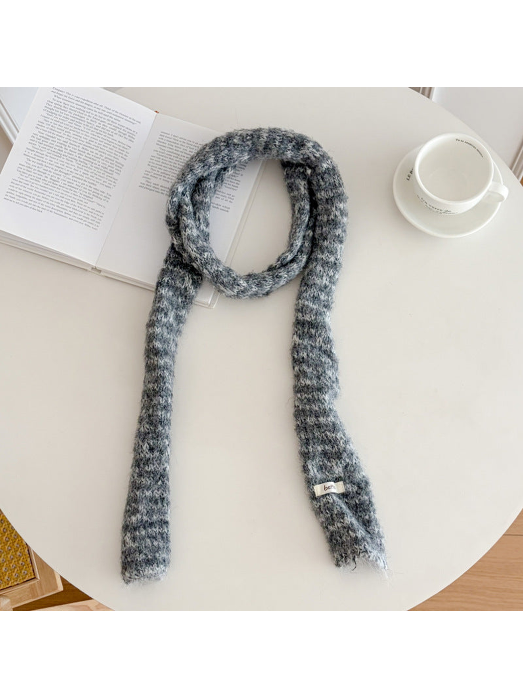 Gray fuzzy striped long narrow scarf laid flat