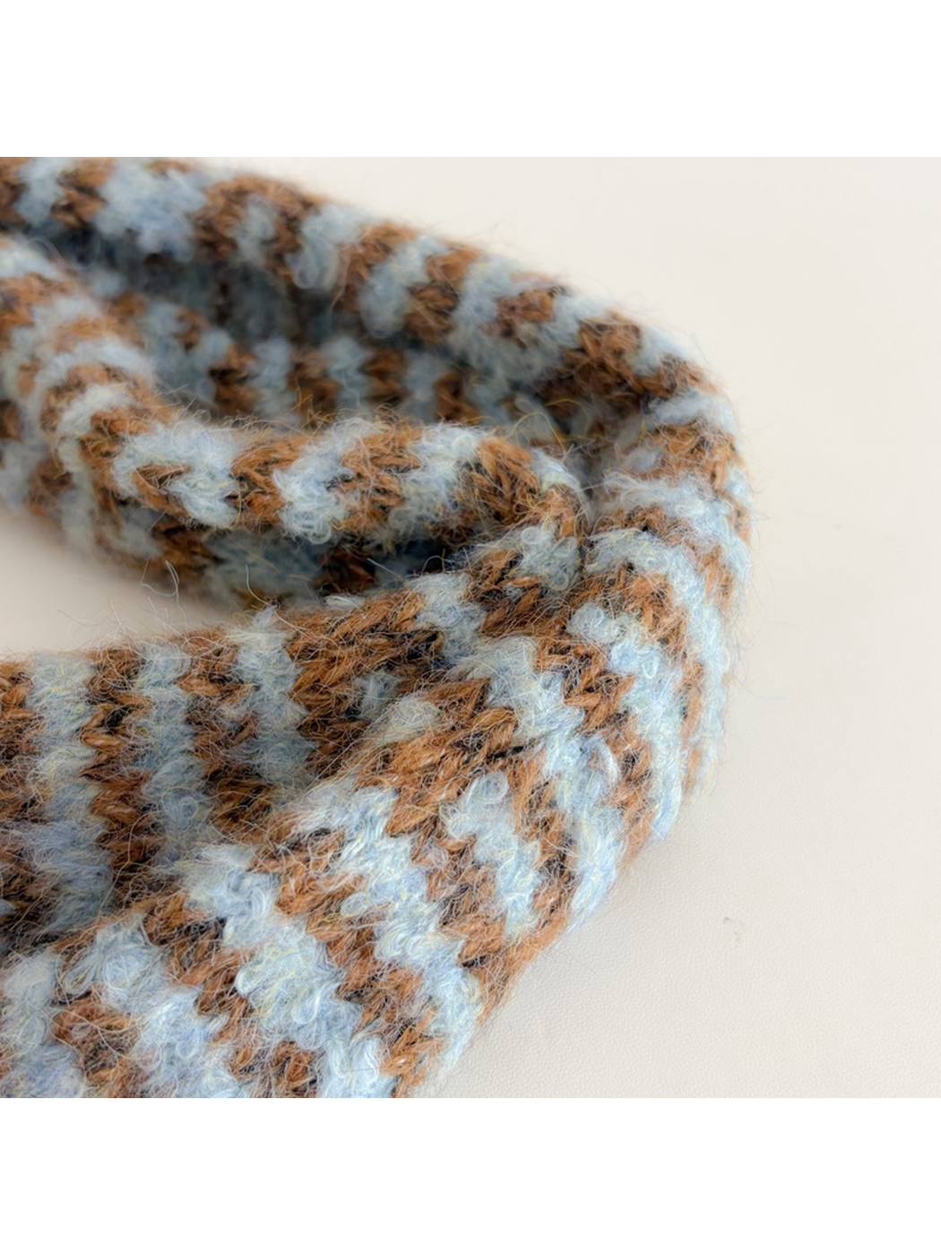 Close-up of the Light Blue and brown striped scarf's fuzzy looped texture