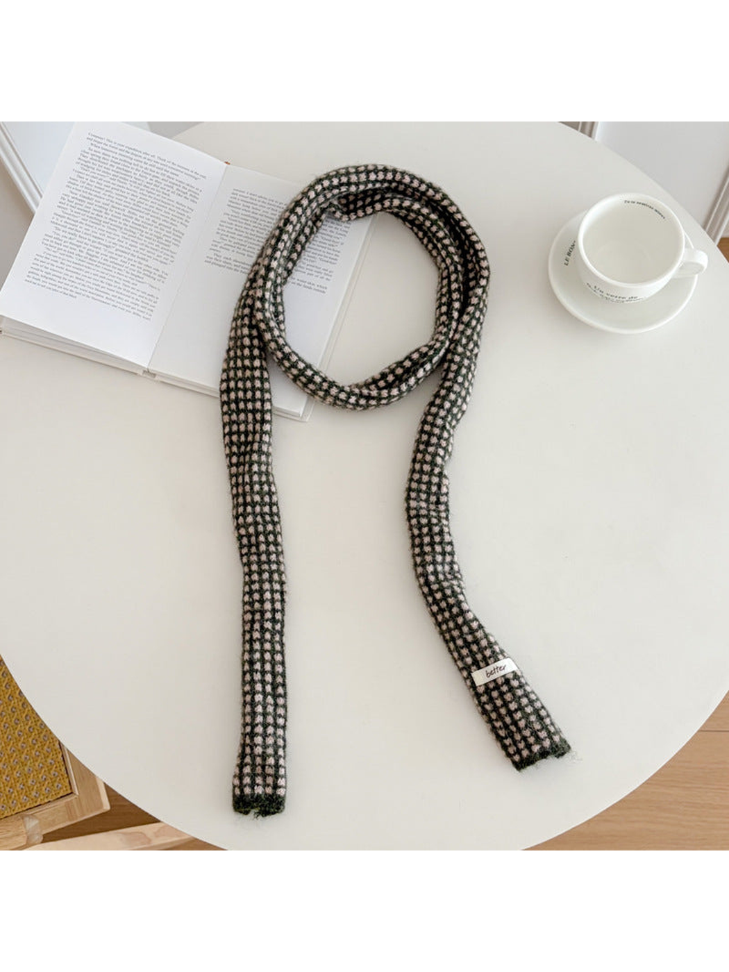 Black narrow check scarf arranged on a round table