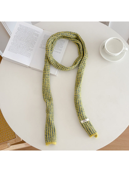 Yellow narrow check scarf arranged on a round table