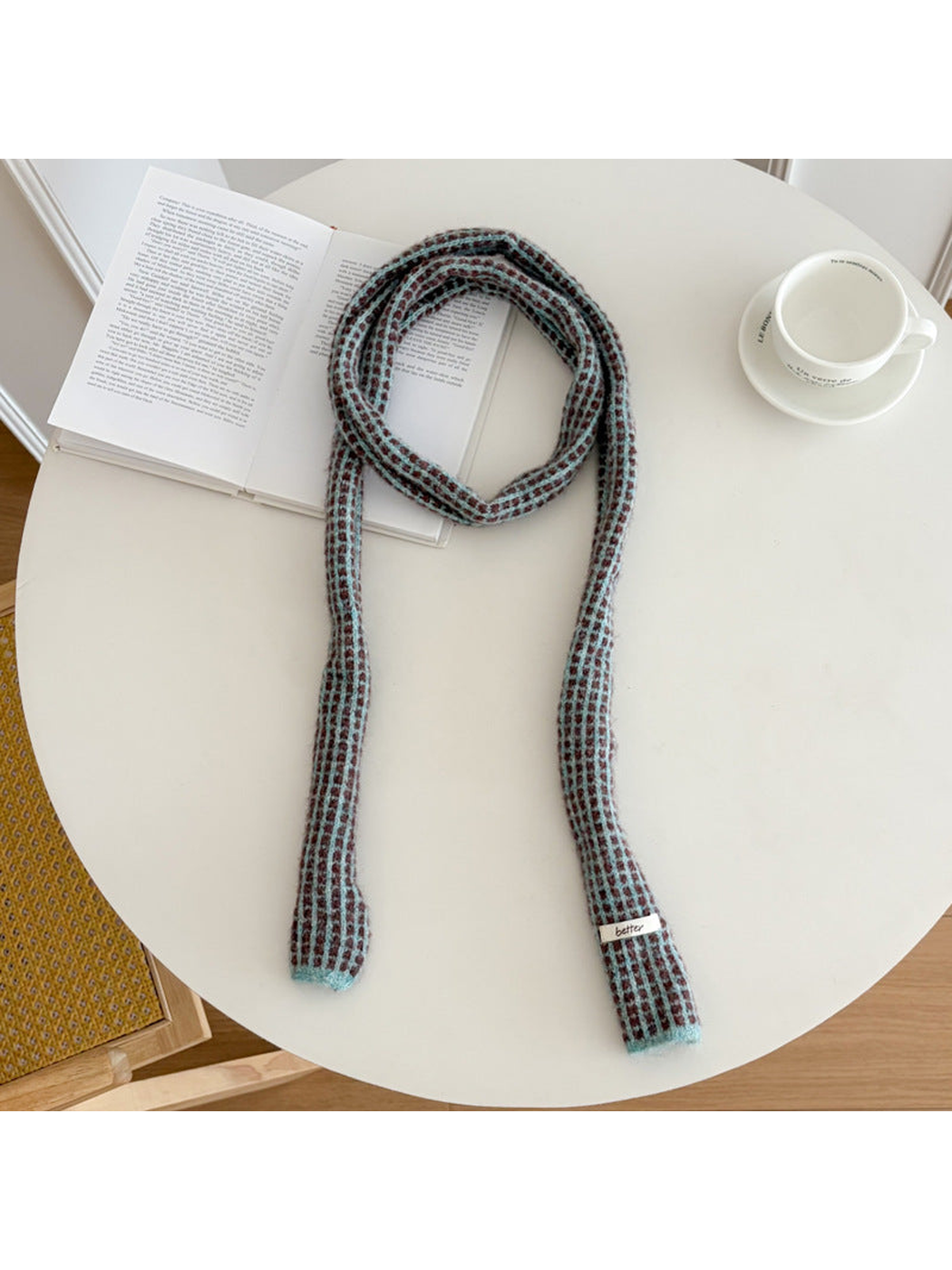 Gray Blue narrow check scarf arranged on a round table