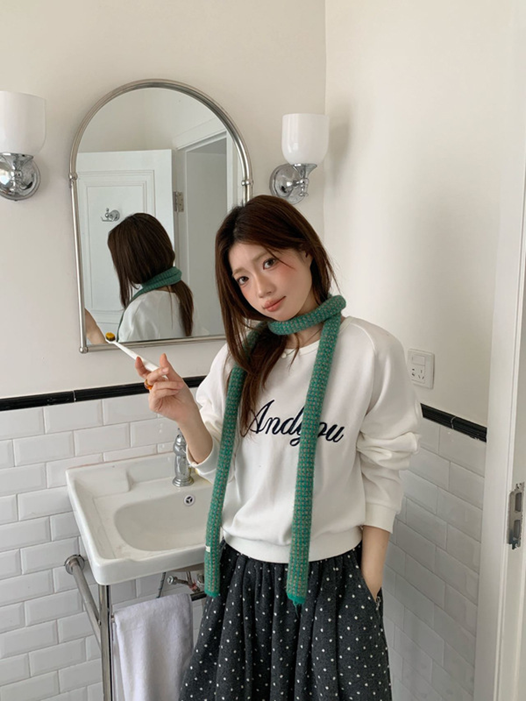 Turquoise check scarf worn in a simple loop with long ends