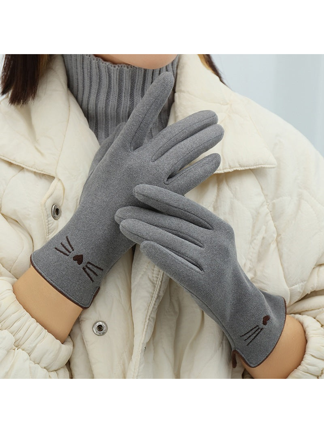 Gray cat-motif gloves worn in a crossed-hand view