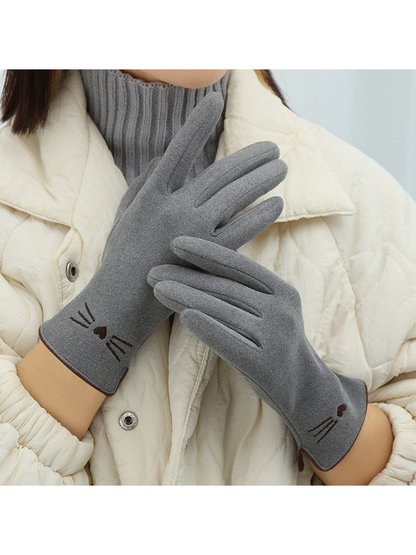 Gray cat-motif gloves worn in a crossed-hand view